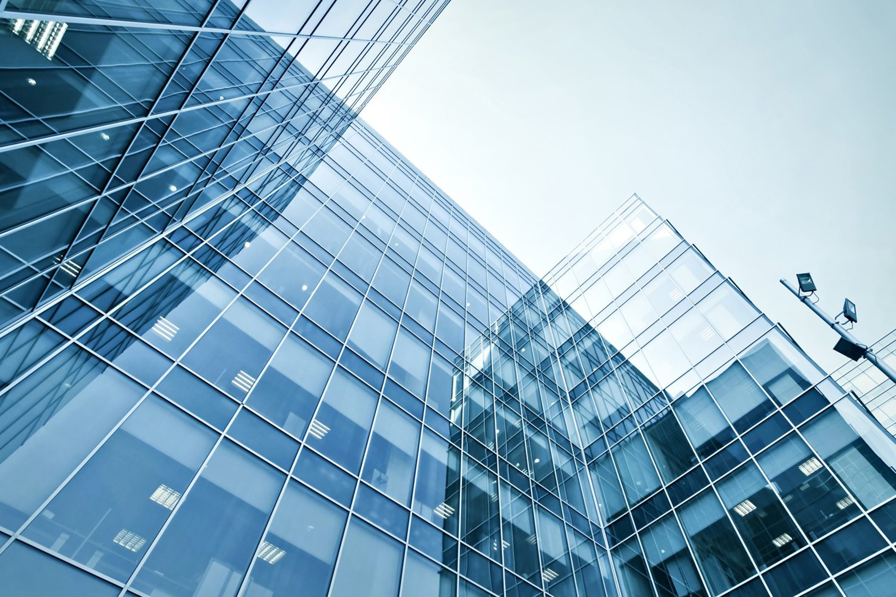 Looking straight up at a glass curtain wall facade